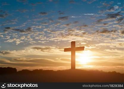 Silhouette of catholic cross, Crucifixion of Jesus christ at sunset background.