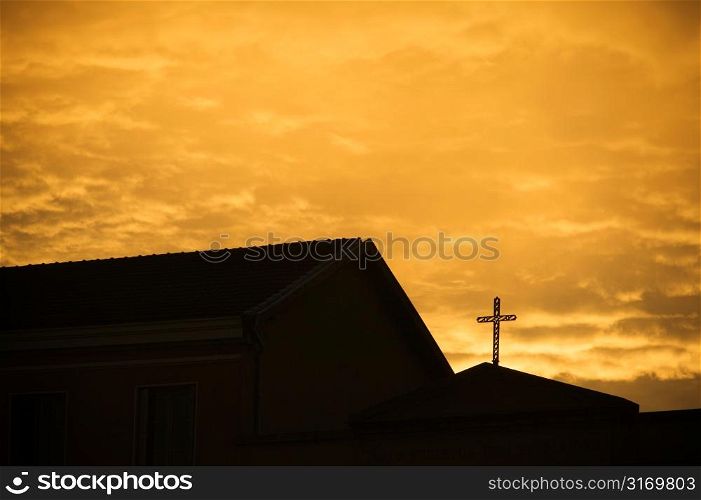 Silhouette of Church With Cross Against Golden Sky