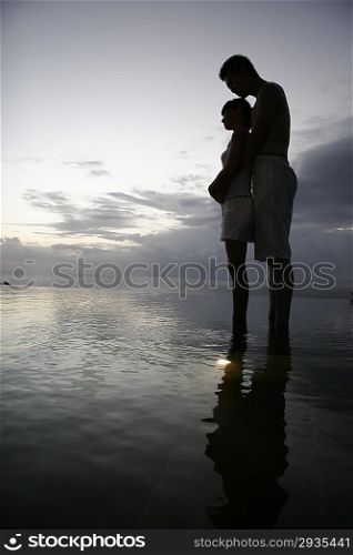 Silhouette of couple standing at the beach