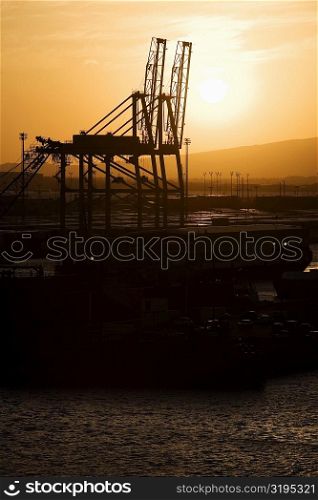 Silhouette of cranes at a commercial dock