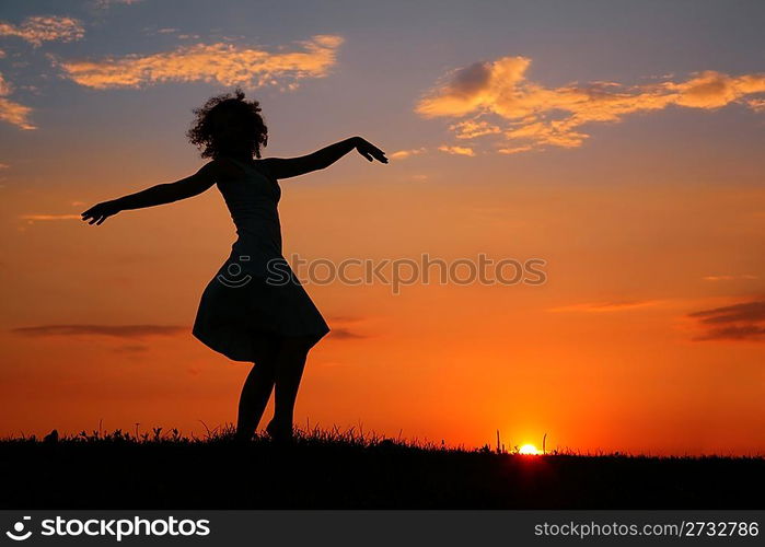 Silhouette of dancing woman on sunset