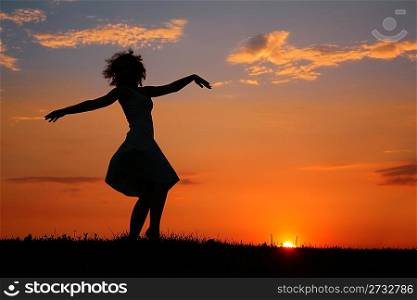 Silhouette of dancing woman on sunset