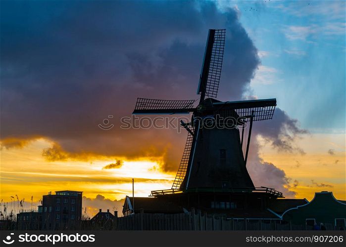 Silhouette of dutch windmill in the village of Zaanse Schans at sunset, Netherlands