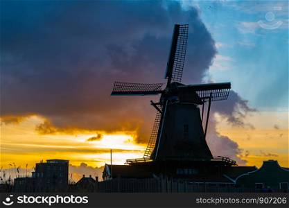 Silhouette of dutch windmill in the village of Zaanse Schans at sunset, Netherlands