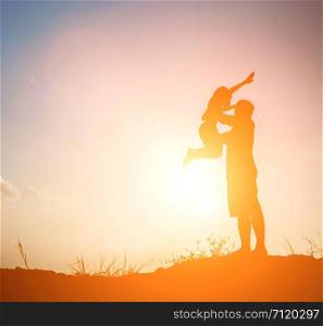 silhouette of father playing with his daughter