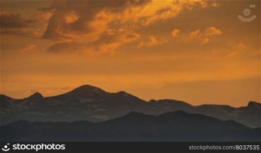 silhouette of Front Range of Rocky Mountains against sunset sky, Longmont, Colorado