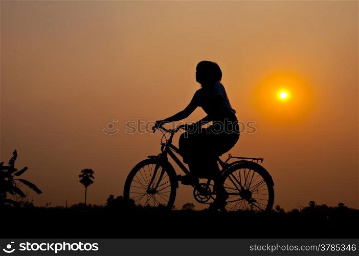 silhouette of girl happy with bicycle