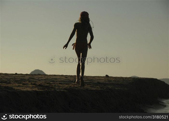Silhouette of girl on the beach