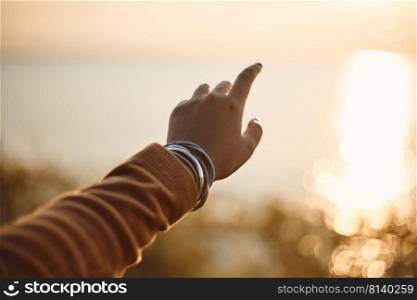Silhouette of hand on sunset background. . hand on sunset background. 