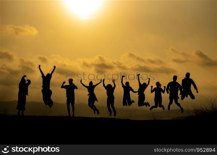 Silhouette of happy business human team making high hands over head in sunset sky evening time background for business teamwork concept and freedom