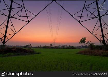 Silhouette of high voltage electric pole Sunset skyline. High voltage electric pole