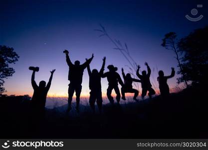 silhouette of hiker open arms at mountain peak