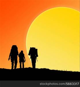Silhouette of hiking friends against sunset and big sun