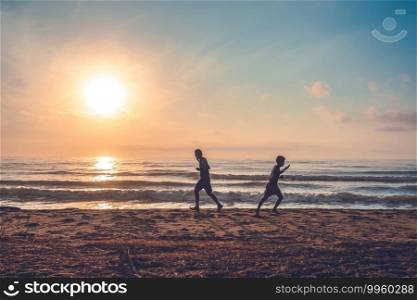 silhouette of jogging man on beach in the morning at sunrise.