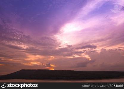 Silhouette of Lam Takong reservoir dam with mountain, Nakhon Ratchasima, Thailand