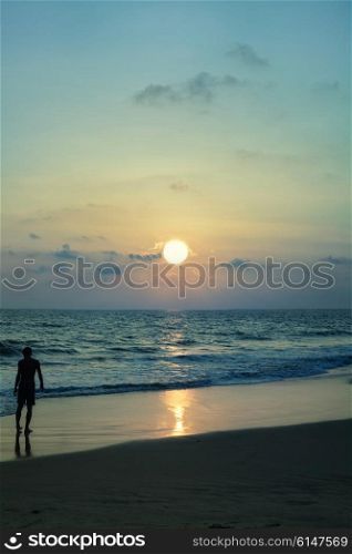 Silhouette of man against the sea sunset
