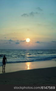 Silhouette of man against the sea sunset