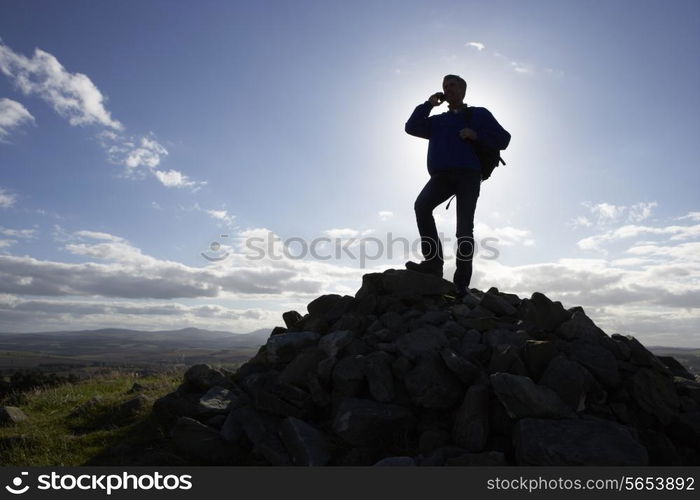 Silhouette Of Man Using Mobile Phone In Remote Countryside