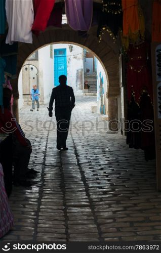 Silhouette of Man Walking in Old Tunisian Medina