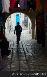 Silhouette of Man Walking in Old Tunisian Medina