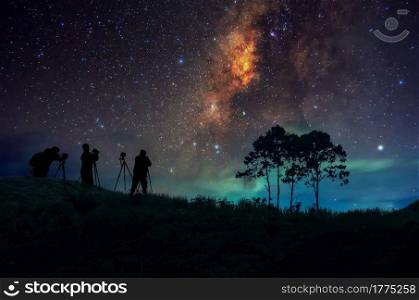Silhouette of man with backpack on hill watching the stars at night, long exposure.. Silhouette man and Milky way