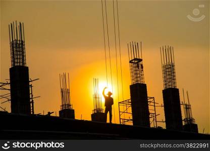 silhouette of man working for building