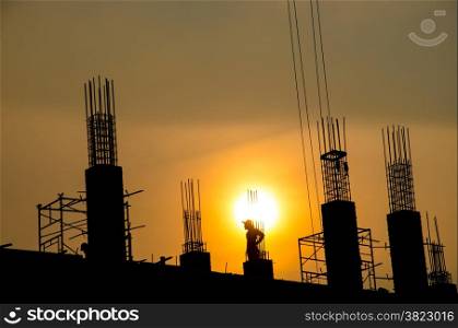 silhouette of man working for building