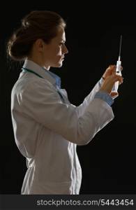 Silhouette of medical doctor woman knocking on syringe