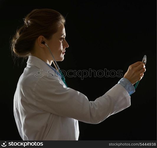 Silhouette of medical doctor woman using stethoscope