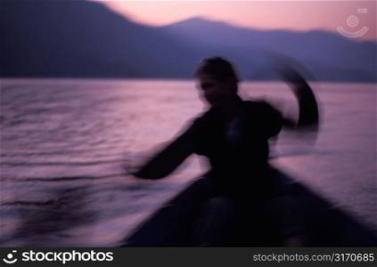 Silhouette of Motion on Purple Water