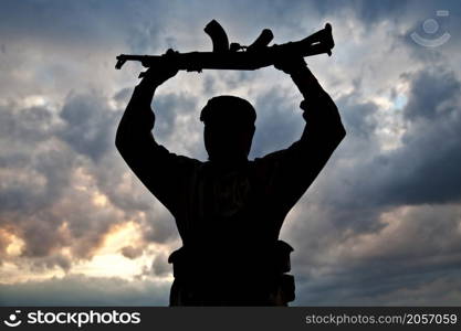 Silhouette of muslim militant with rifle