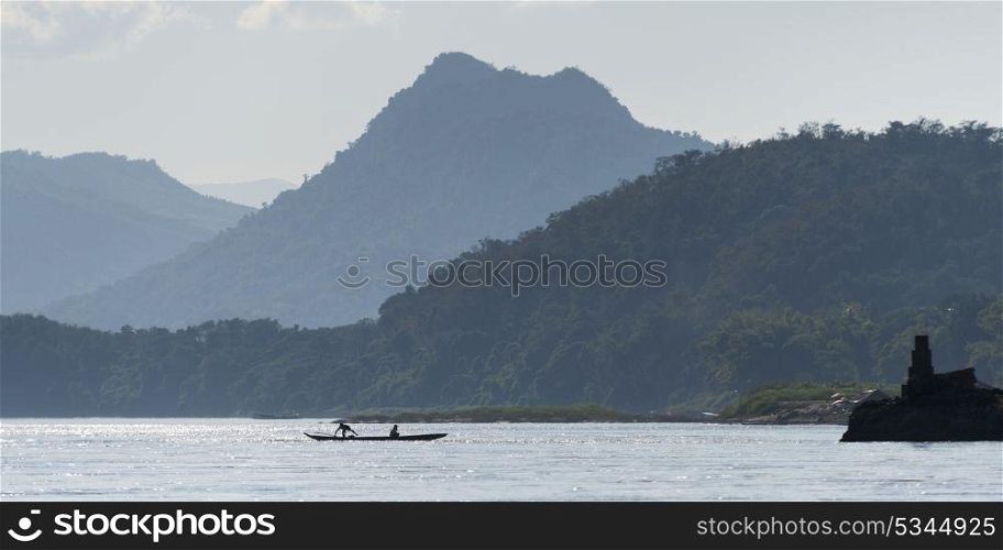 Silhouette of people on boat in River Mekong, Laos