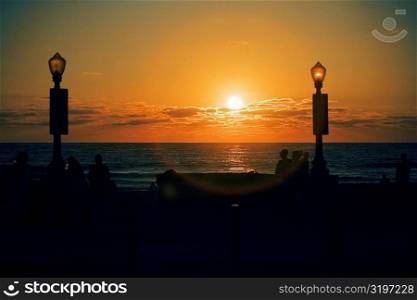 Silhouette of people on the beach at dusk, San Diego, California, USA