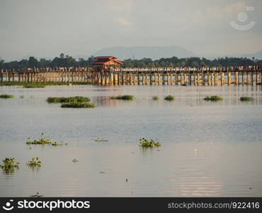 Silhouette of people walking on Bridge U-Bein at sunset scene