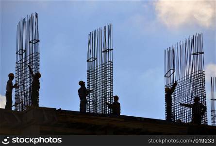 Silhouette of people working and building construction.