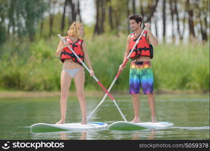 silhouette of perfect couple engage standup paddle boarding