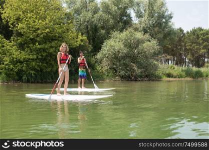 silhouette of perfect couple engage standup paddle boarding