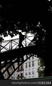 Silhouette of person crossing a bridge in Paris France