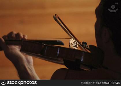 Silhouette of person playing the violin