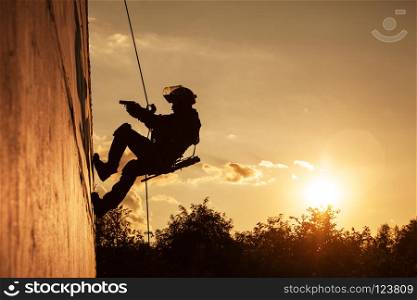 Silhouette of police officer during rope exercises with weapons