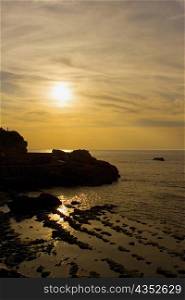 Silhouette of rocks in the sea at dusk, Biarritz, Basque Country, Pyrenees-Atlantiques, Aquitaine, France