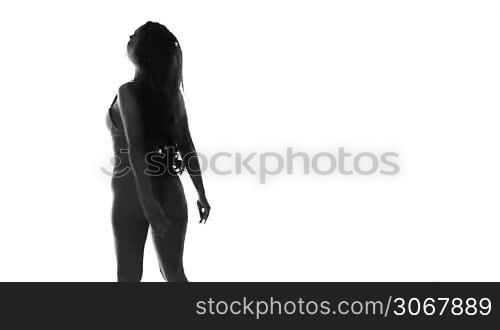 silhouette of sexy dancing woman in lingerie