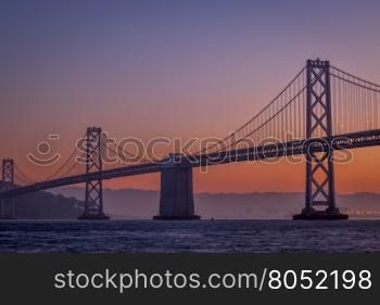 silhouette of suspension bridge at dawn (San Francisco Bay Bridge)