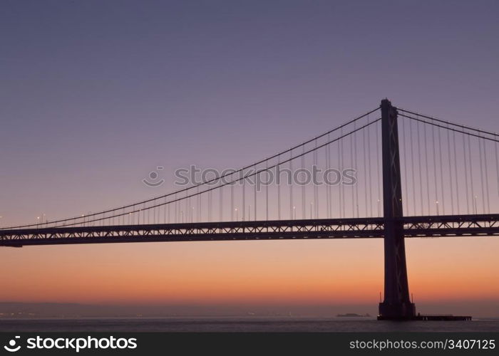 silhouette of suspension bridge detail at dawn (San Francisco Bay Bridge)