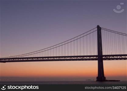 silhouette of suspension bridge detail at dawn (San Francisco Bay Bridge)