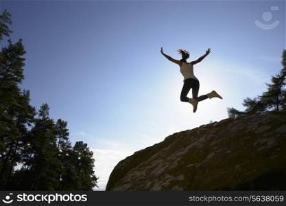 Silhouette Of Teenage Girl Leaping In Air