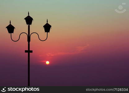 silhouette of the lamp with the sunrise