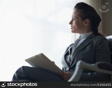 Silhouette of thoughtful business woman with tablet pc
