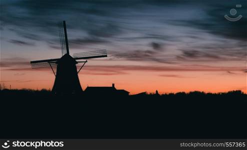 Silhouette of traditional Dutch windmill at sunset at sunset.. Silhouette of traditional Dutch windmill at sunset at sunset