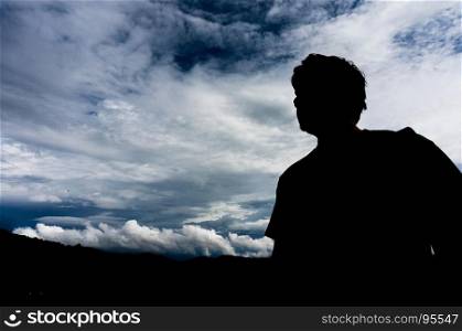 silhouette of traveler man with sky from a mountain